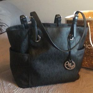 Michael Kors logo embossed purse.